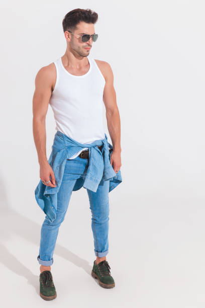 istock muscular man in undershirt and jeans looks to side 1023472928