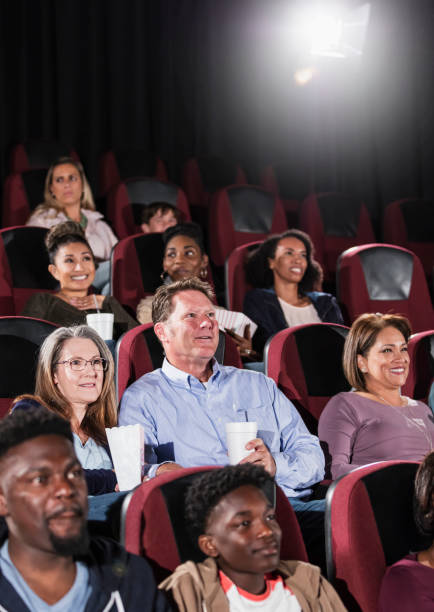 istock Multi-ethnic audience watching movie in theater 1023473174