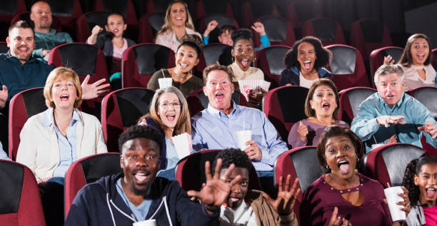 istock Multi-ethnic audience watching movie in theater 1023475812