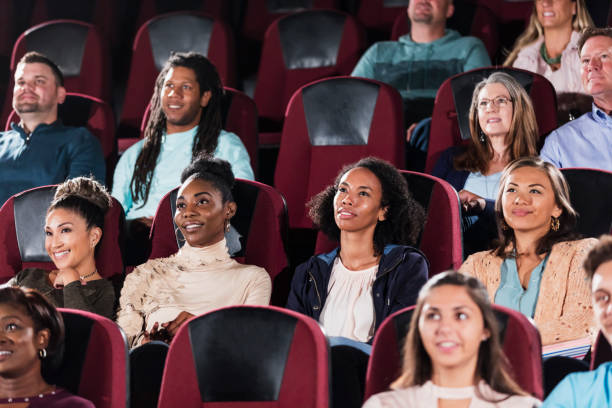 istock Multi-ethnic audience watching movie in theater 1023476728