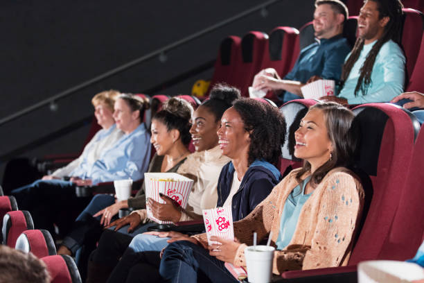istock Multi-ethnic audience watching movie in theater 1023476922