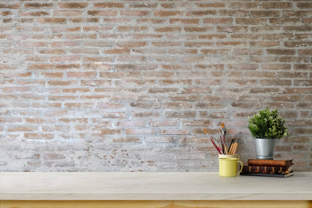 istock Minimal workspace with mockup desk and brick wall. 1023477400