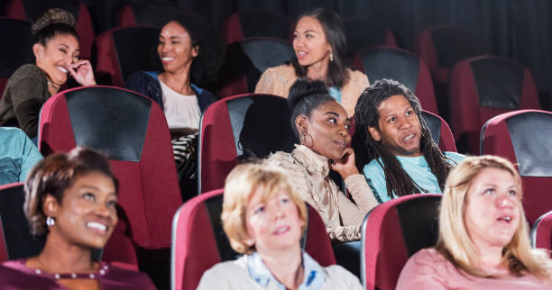 istock Multi-ethnic group in movie theater, mostly women 1023477418