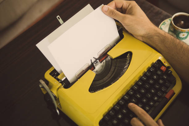 istock A man looks at paper on a yellow typewriter. 1023485806