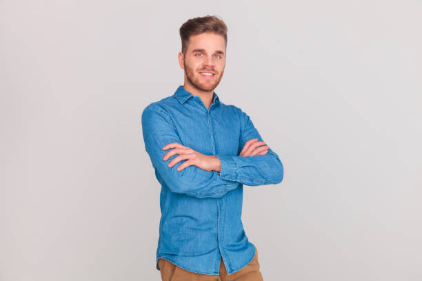 istock portrait of confident casual man standing with hands folded 1023486160
