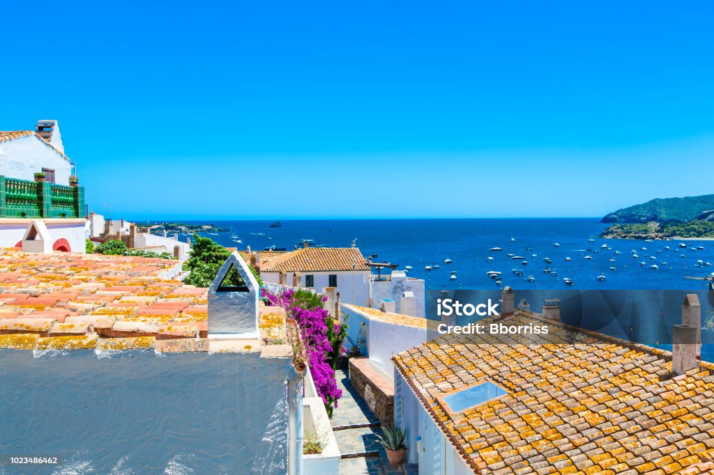 View on Street in Cadaques, Catalonia, Spain near of Barcelona. Scenic old town with nice beach and clear blue water in bay. Famous tourist destination in Costa Brava with Salvador Dali landmark Barcelona - Spain Stock Photo