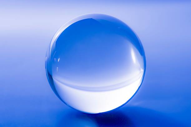 istock Glass ball in abstract blue light 1023486858
