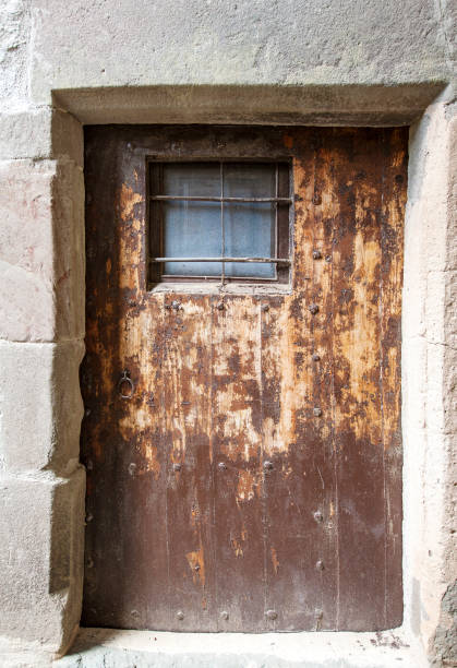 istock ancient wooden door with a metall lattice 1023490964