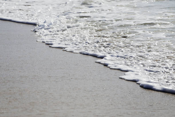 istock Sand and waves in Caribbean Beach, Antigua&Barbuda 1023495750