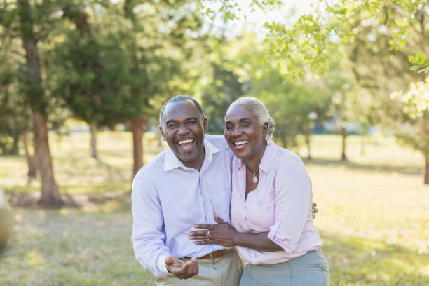 Mature couple outdoors at park, laughing