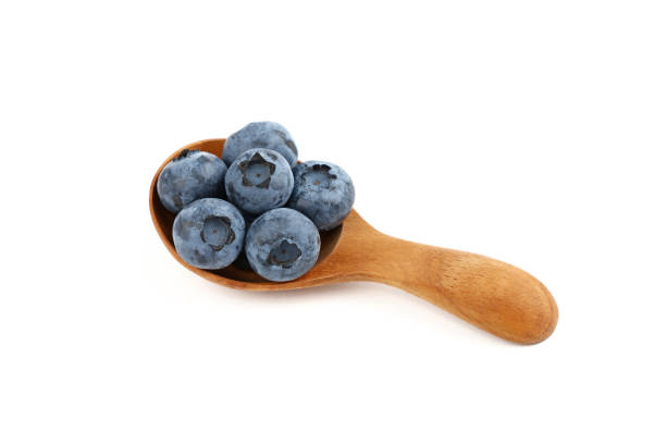 istock Fresh blueberry in wooden spoon isolated on white 1023496844
