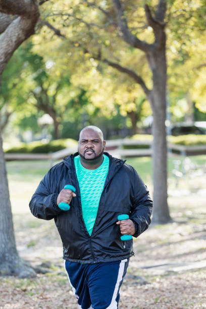 istock Mature African-American man exercising, jogging in park 1023501840