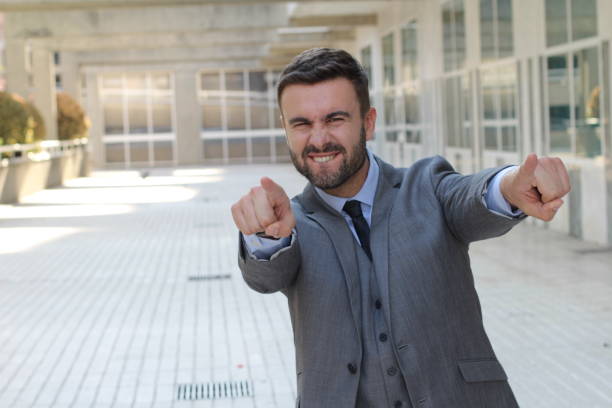 confident businessman pointing at camera - business men humor macho imagens e fotografias de stock