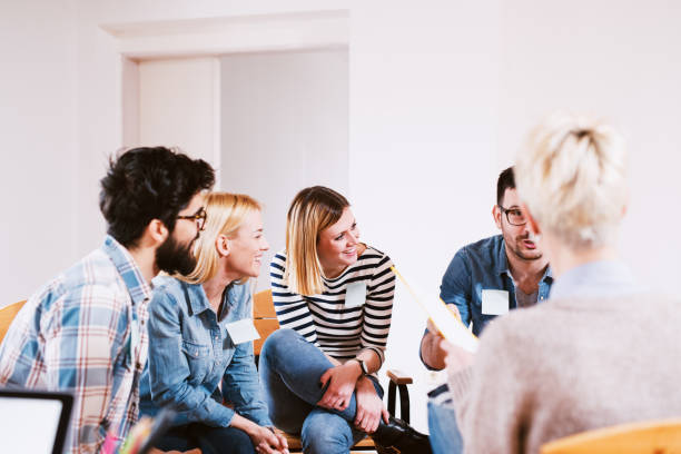 istock Group of people sitting in a group therapy and talking about their problems. 1023505376