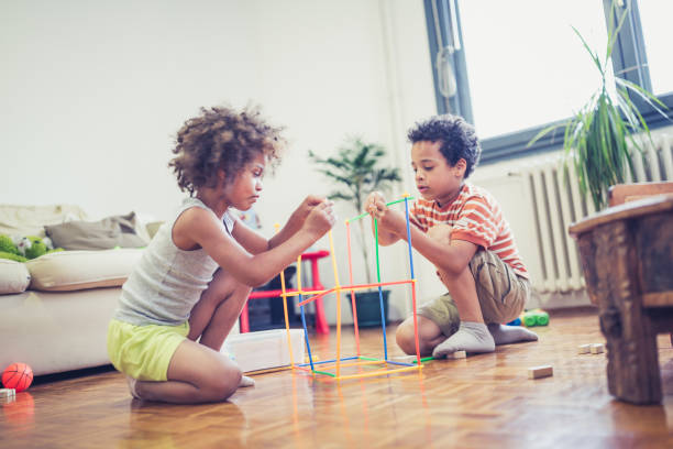 istock Cute mixed - race siblings having fun, playing at home 1023506112
