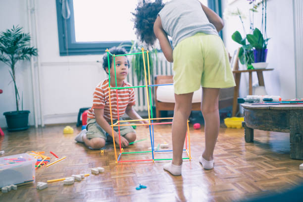 istock Cute mixed - race siblings having fun, playing at home 1023506124