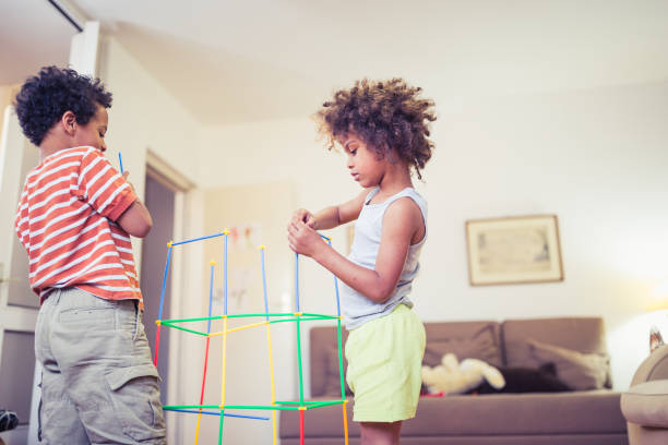 istock Cute mixed - race siblings having fun, playing at home 1023506130