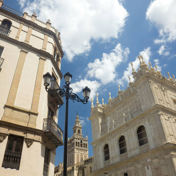 Low angle view of antique buildings and the Giralda tower in old town Seville, Spain