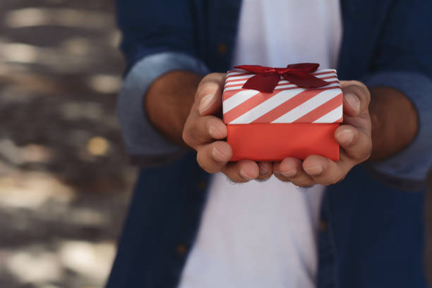 istock Young arabic man with a red gift box 1023514096