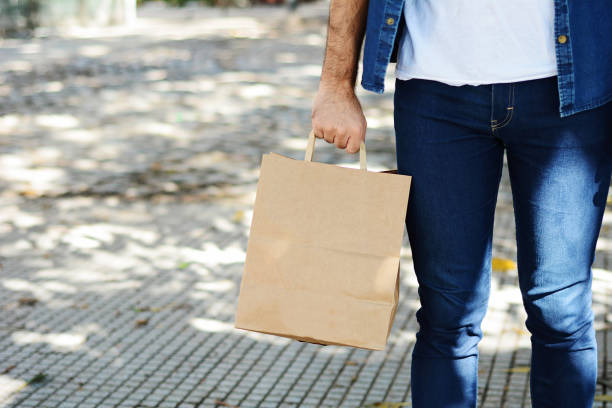 istock Young man holding shopping bag 1023514098