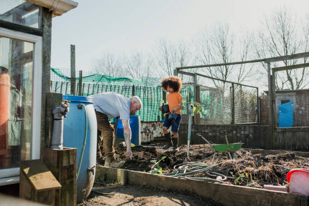 istock Helping Grandad in the Allotment 1023514404