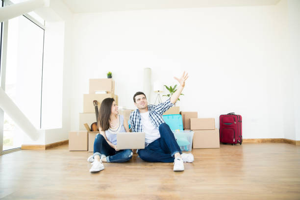 istock Couple Doing Online Shopping Using Laptop In New House 1023517176