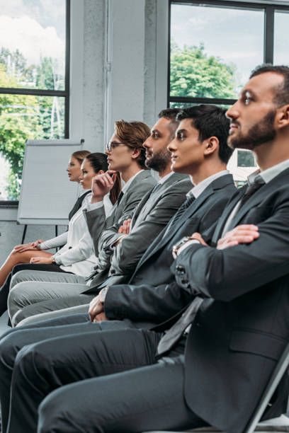 istock side view of businesspeople sitting on chairs during training in hub 1023518420