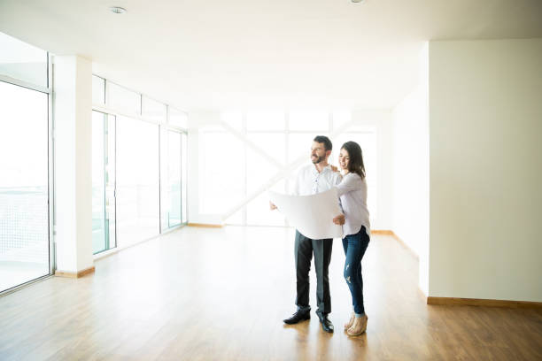 istock Owners Examining Blueprints Of Their New House 1023523836
