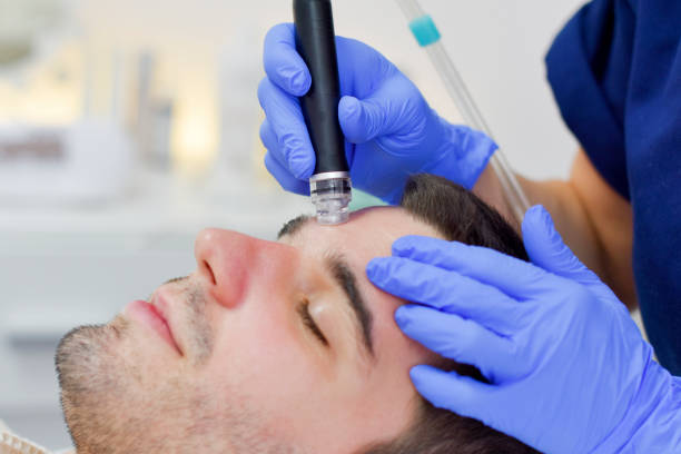 istock Young man on face treatment 1023524274