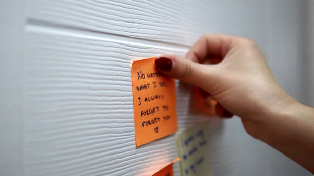 istock Adding a message sticker on board. Closeup of creative business team brainstorming ideas and concepts 1023524780