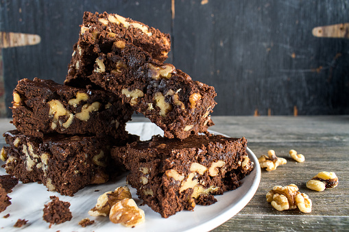 stack of homemade Walnut and chocolate brownies on plate