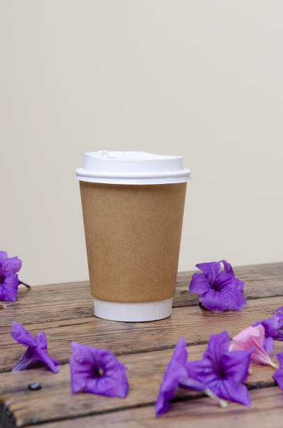 istock Paper cup of coffee on the table with flower 1023528810