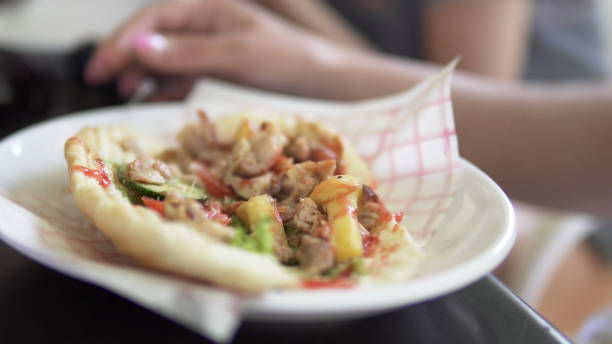 Chicken Doner Diner Sandwich Wraped on Plate, cinematic handheld shot