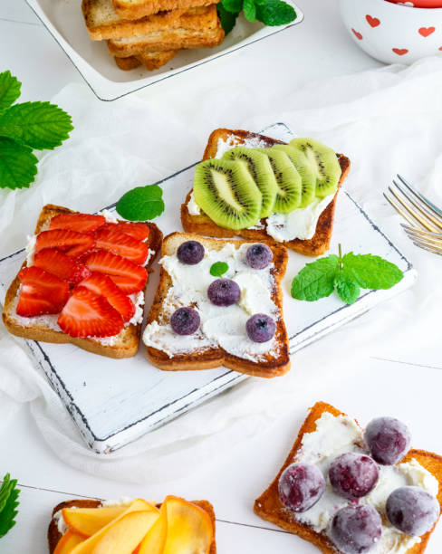 istock toasts with soft cheese, strawberries, kiwi, cherries and blueberries 1023532622