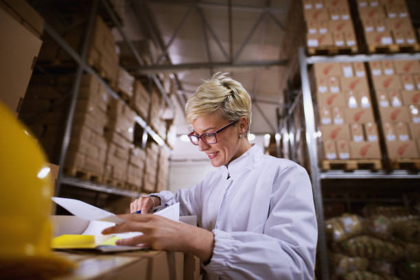istock Young female worker is looking at documents with satisfaction in a storage room. 1023533710