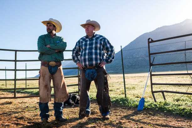 istock Low angle view portrait of ranchers standing inside an animal pen 1023534274