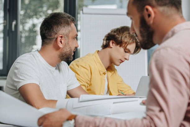 istock businessmen sitting at table during meeting in office 1023534456