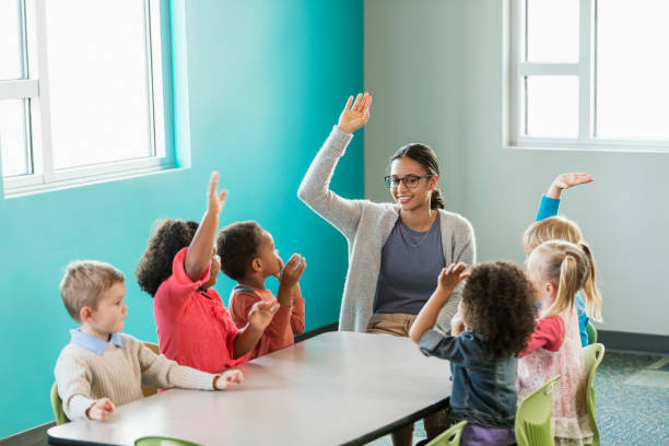 istock Multi-ethnic preschool teacher and students in classroom 1023541738