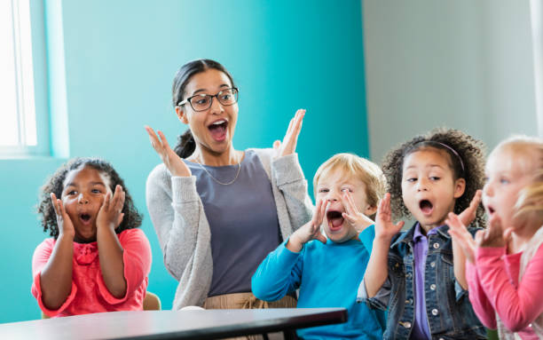 istock Multi-ethnic preschool teacher and students in classroom 1023542420
