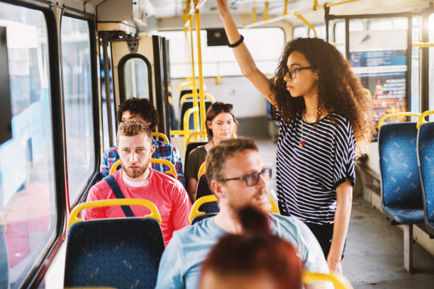 istock Group of people mixed age sitting and standing in a bus. 1023542462