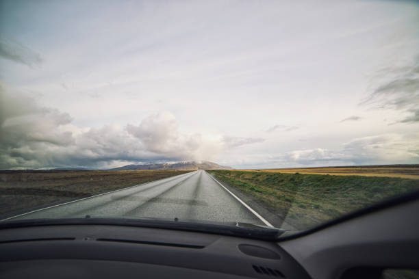 istock Scenic empty road in Iceland, view through the windshield 1023542900