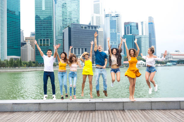istock Young adults having fun and jumping on street 1023545784