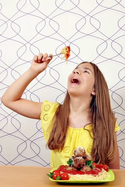 istock The girl eats spaghetti with meatballs 1023545808