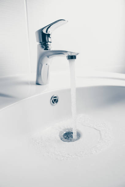 istock faucet and wash sink with flowing water 1023548960