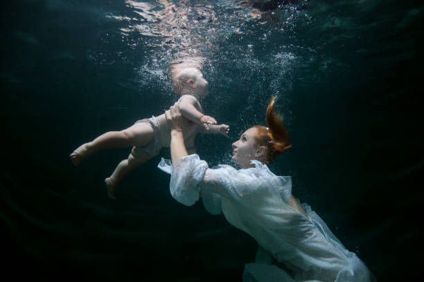 istock Mother teaches the baby to dive. 1023551124