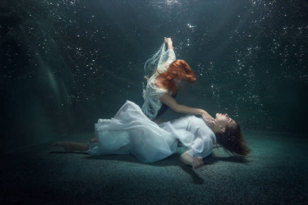 Two young women under the water.