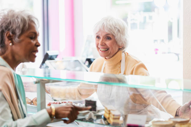 istock Woman helping customer in pastry shop 1023552896