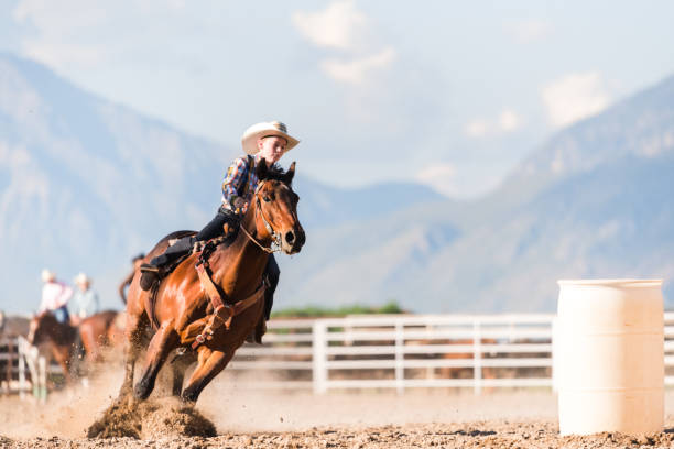istock Young boy horse riding at speed at a ranch 1023553090