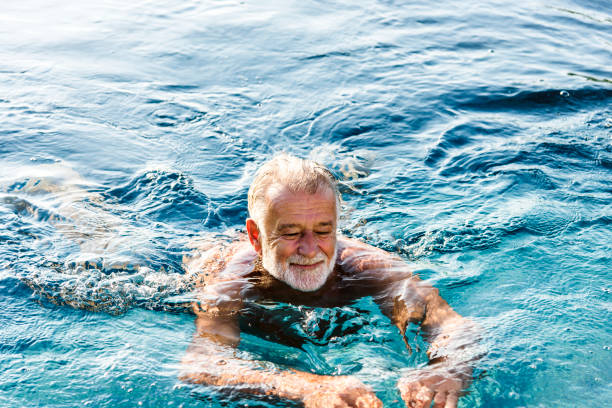 istock Senior man chilling in swimming pool 1023559080