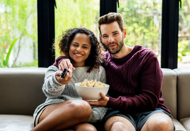istock Couple watching TV having popcoprn 1023559314